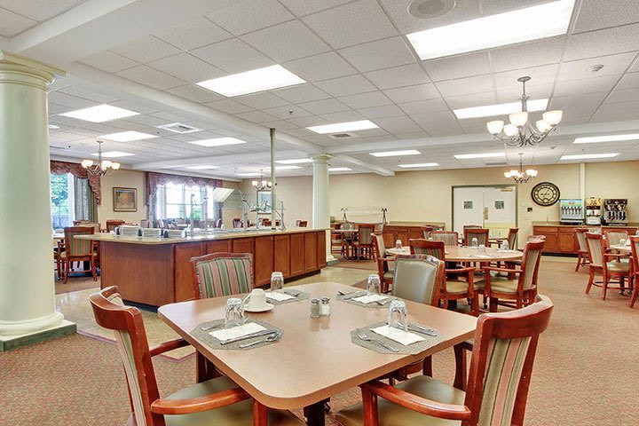 Spacious restaurant dining area with tables and buffet